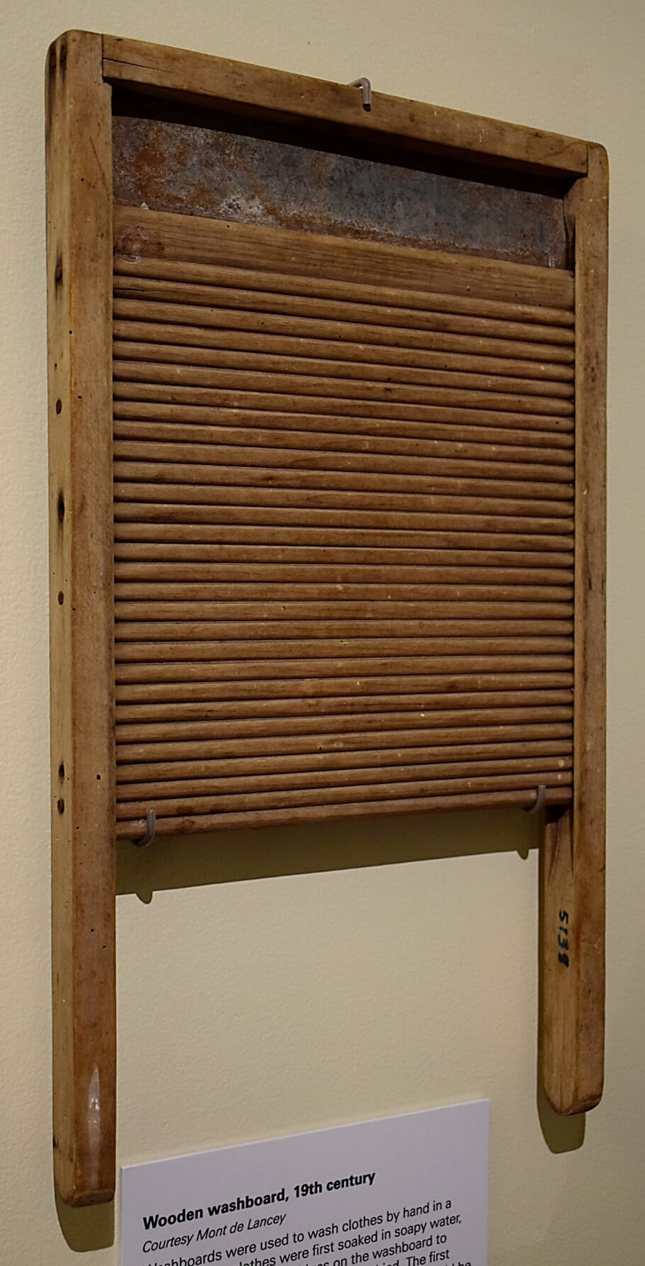 Doing the laundry in the 1960s. A lady is using a washboard to clean the  dirty laundry. The tool was designed for hand washing clothing rubbing them  agains the series of ridges